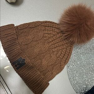 Mackage Nina beanie in the camel color with a natural fur pom
